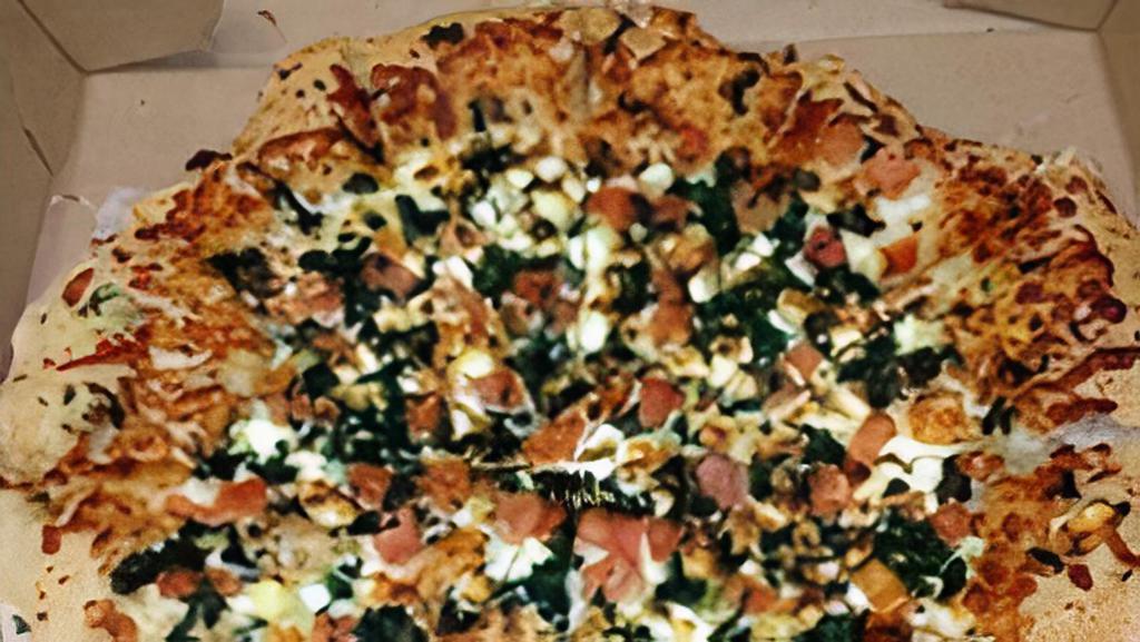 Mediterranean · A white garlic pizza topped with tomatoes, spinach, Feta, and Mozzarella.