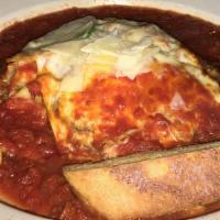 Lasagna · Stuffed with sausage, ground beef, ricotta, mozzarella and parmigiano cheese served in a plu...