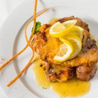 Pollo Francese · Chicken breast dipped in egg batter, sautéed until golden brown and served in a lemon white ...
