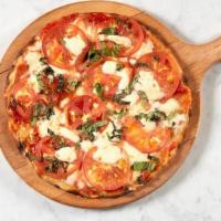 Round Caprese · San Marzano tomato, Fior di Latte mozzarella, sliced tomato, basil and oregano