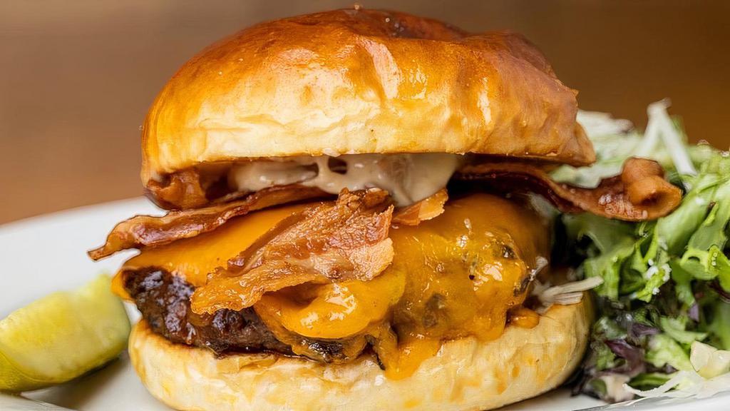 Steakhouse Burger · Angus beef, thick cut bacon, caramelized onions, cheddar, garlic aioli
