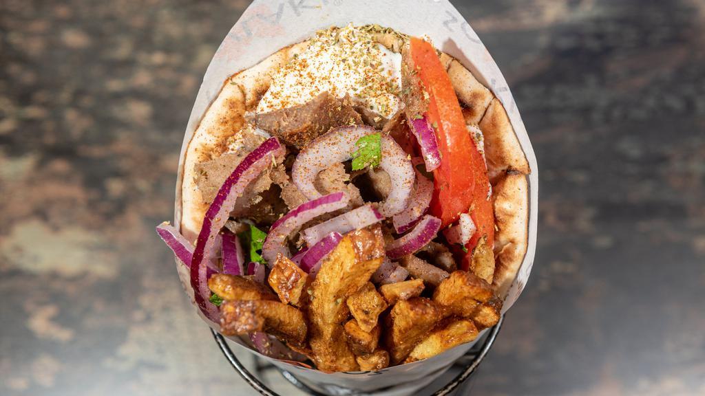 Lamb Gyro Pita Sandwich · Mouthwatering, slow roasted slices of our delicious lamb gyro, carved off a vertical rotisserie and wrapped inside a warm and fluffy pita, with delicious fillings and sauce of your choice.