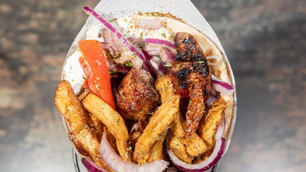 Pork Souvlaki Pita Sandwich · Perfectly grilled pork souvlaki, wrapped inside of a warm and fluffy pita, with delicious fillings and sauce of your choice.
