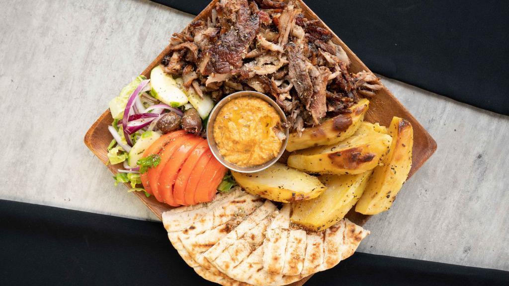 Pork Gyro Platter · Double portion of our slow roasted, hand-stacked pork gyro, over your choice of up to 2 sides and choice of dip. Served with a house salad and pita bread.