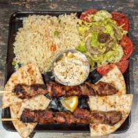 Pork Souvlaki Platter · 2 sticks of our hand-skewered pork souvlaki, over your choice of up to 2 sides and choice of...