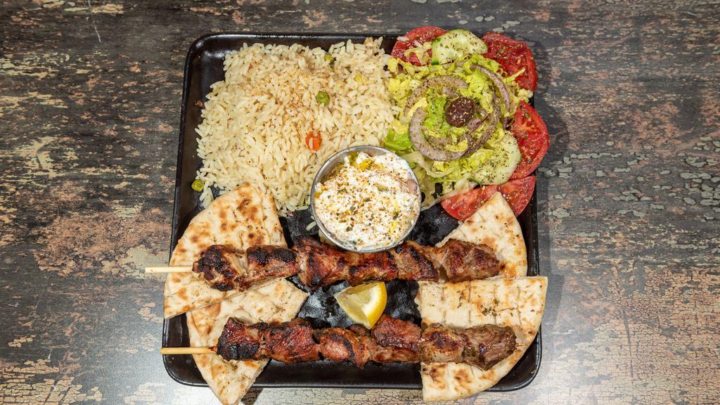 Pork Souvlaki Platter · 2 sticks of our hand-skewered pork souvlaki, over your choice of up to 2 sides and choice of dip. Served with a house salad and pita bread.