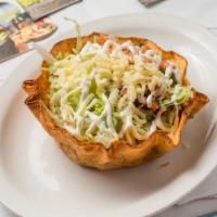 Taco Salad · Crispy flour tortilla bowl filled with ground beef or shredded chicken, cheese, beans, lettu...
