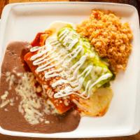 Enchiladas Bandera · Three corn tortillas, one with chicken, one with beef and one with cheese. Topped with three...