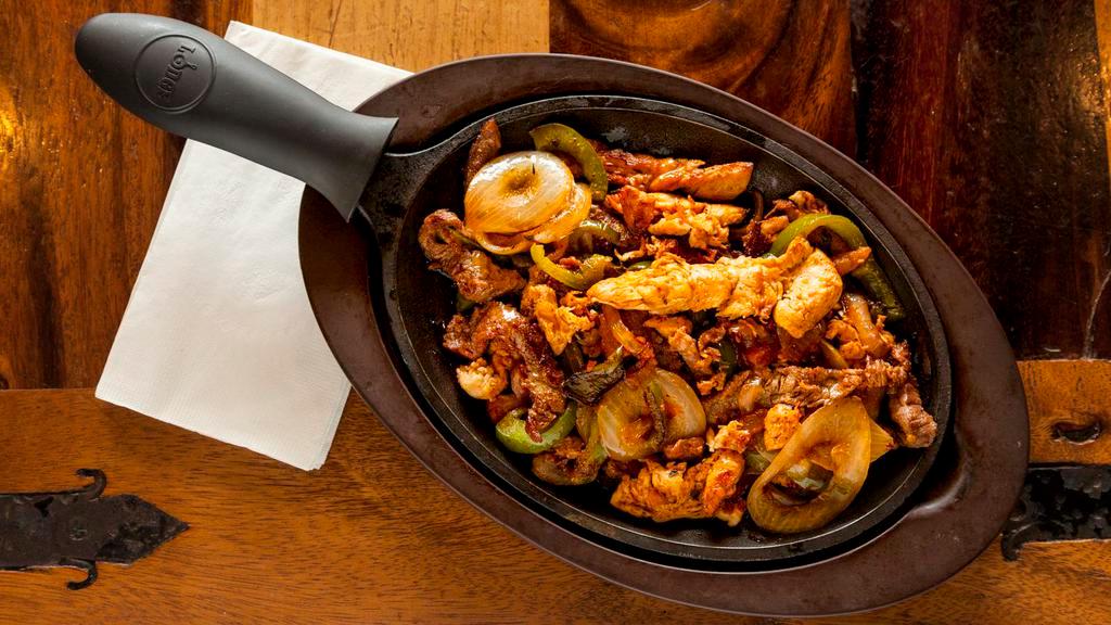 Fajitas For 2 · The perfect mix of beef, chicken, shrimp, and pork. Served in a sizzling skillet with grilled bell peppers and onions. Served with a side of rice, refried beans, pico de gallo, and sour cream.