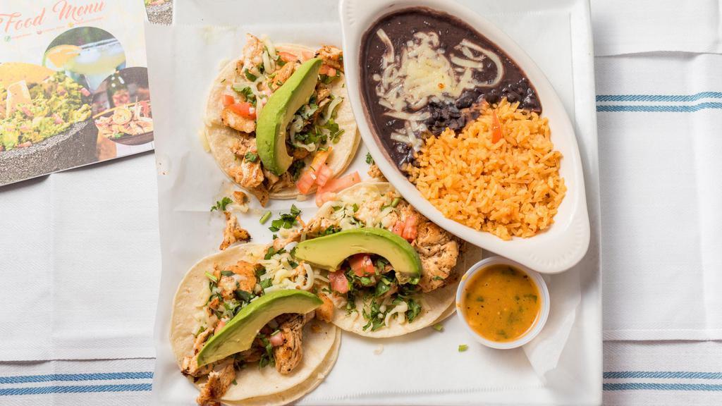 Tacos De Pollo - 3 Pcs · Grilled chicken with tomato, cilantro, queso fresco, avocado, and chile de arbol sauce. Served with a side of rice and black beans.