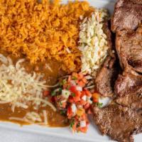 Carne Asada · Tender rib-eye steak served with a side of rice and beans accompanied with pico de gallo