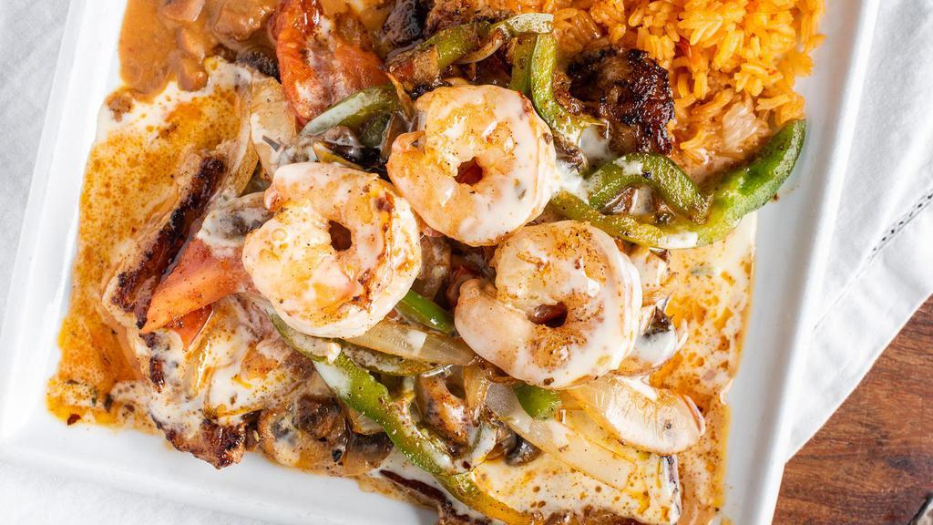 El Paisano  Chicken · Recommended. Your choice of a ten ounce t-bone steak or a grilled chicken breast topped with shrimp, mushrooms, onions and peppers drizzled with our cheese sauce. Served with a side of rice and beans accompanied with tortillas. Starting at 290 calories.