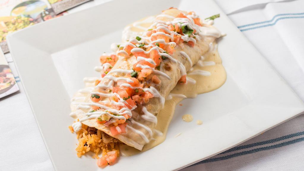 Burrito San José · Recommanded. Ten inch flour tortilla filled with grilled chicken chorizo, rice and beans topped with cheese sauce pico de gallo and sour cream. 1310 calories.