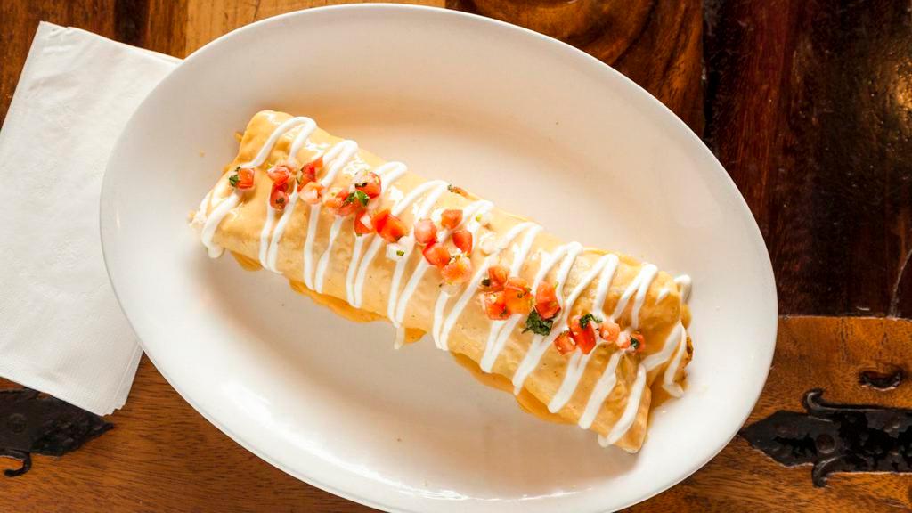 Burrito Chipotle · One ten inch flour tortilla filled with grilled chicken and peppers, rice, beans, topped with creamy chipotle sauce, pico de gallo and sour cream. 1090 calories.