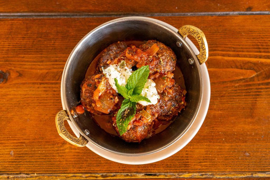 Yiayia'S Meatballs · Traditional and freshly ground beef meatballs served over a white navy bean stew “fasolatha” and a preserved lemon yogurt sauce.