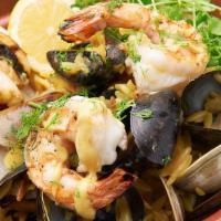 Seafood Yuvetsi · Grilled diver scallops, calamari, shrimp, mussels, clams over saffron orzo crumbled feta