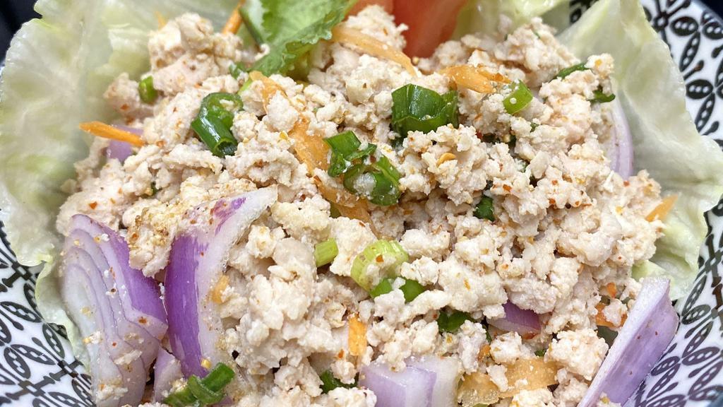Larb Gai · Minced chicken, scallion, red onion, carrots and cucumber with spicy lime dressing.