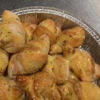 Garlic Knots · Four pieces. A classic snack, our garlic knots are strips of pizza dough tied in a knot, bak...