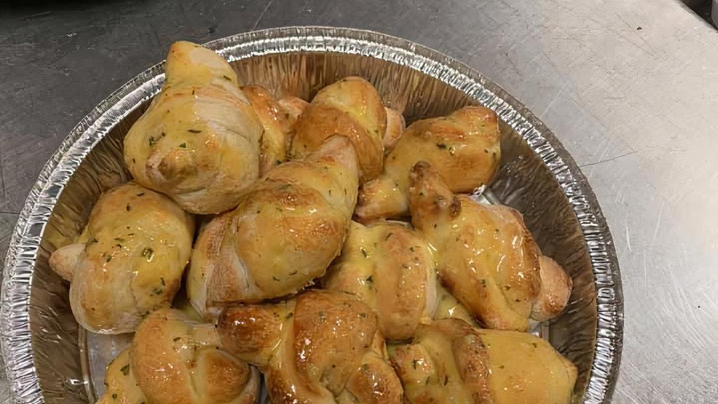 Garlic Knots · Four pieces. A classic snack, our garlic knots are strips of pizza dough tied in a knot, baked, and then topped with melted butter, garlic, and parsley.