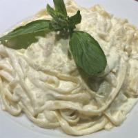 Fettuccine Alfredo · Fettuccine pasta in a creamy alfredo sauce, topped with grated Parmesan cheese.