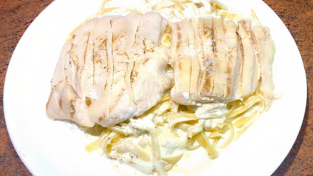 Fettuccine Alfredo With Grilled Chicken · Grilled chicken strips over fettuccine pasta in a creamy alfredo sauce topped with grated Parmesan cheese.