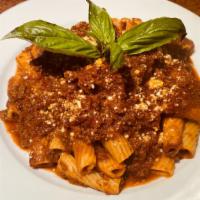 Rigatoni Bolognese · Rigatoni pasta tossed with our zesty meat sauce and finished with grated Parmesan cheese.