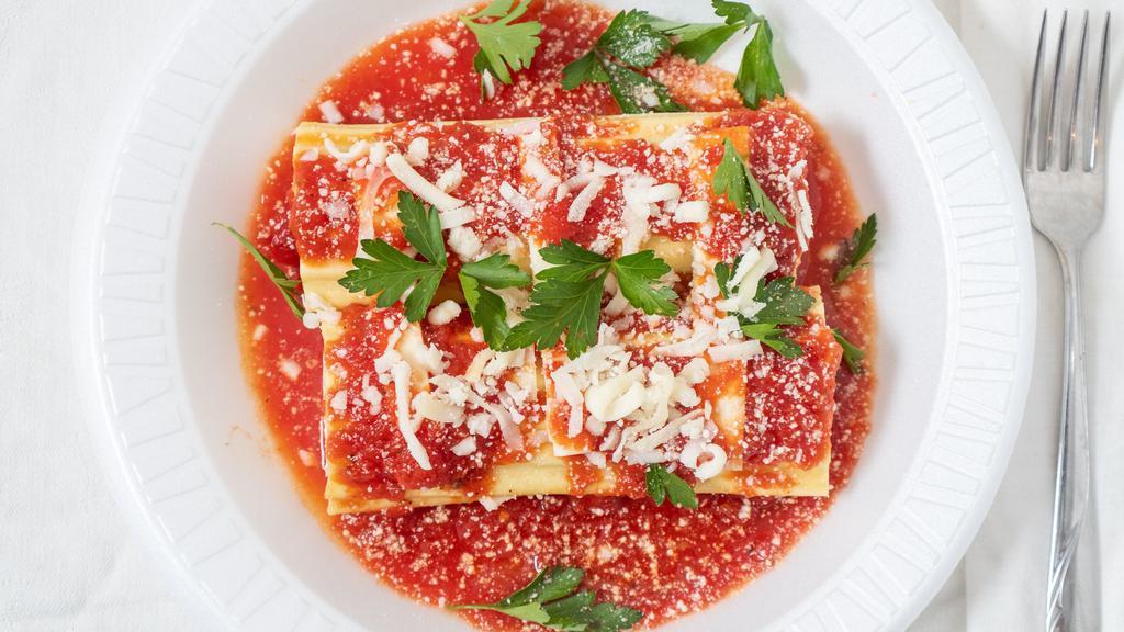Baked Manicotti · Pasta stuffed with ricotta and Parmesan cheese, fresh tomato sauce topped with melted mozzarella.