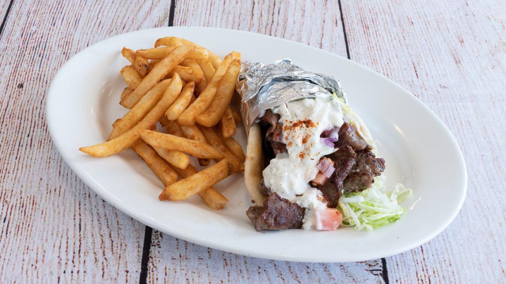 Classic  Greek Gyro · Gyro Meat ,  wrapped with  Lettuce ,Tomato and Onion , on a Pita  with
Tzatziki on the Side.   Served with French Fries