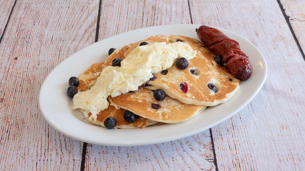 Blueberry Hill Pancakes · Stack of Fresh Blueberry Buttermilk Pancakes topped with Egg Whites & Beef Sausage.