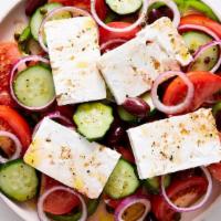 Greek Salad · Romaine lettuce, Feta cheese, black olives, tomatoes, cucumber, onions, anchovies, dolmadaki...