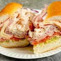 The Monte Cristo · Ham, turkey, melted Swiss cheese, lettuce, tomato, onion, and Russian dressing on a toasted ...
