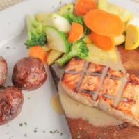 Wood Grilled Salmon · Grilled on a cedar plank topped with lemon butter sauce, served with house vegetables and ga...