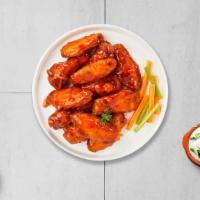 Buffalo Herd Chicken Wings · Fresh chicken wings breaded, fried until golden brown, and tossed in buffalo sauce. Served w...