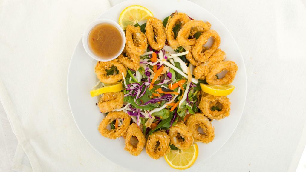 Our Famous Sesame Calamari Salad · Asian greens, miso ginger dressing, peanut sauce, scallions and sesame seeds.