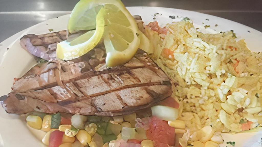 Caribbean Swordfish · Grilled Swordfish topped with mango salsa served with chefs vegetable & mashed potato
