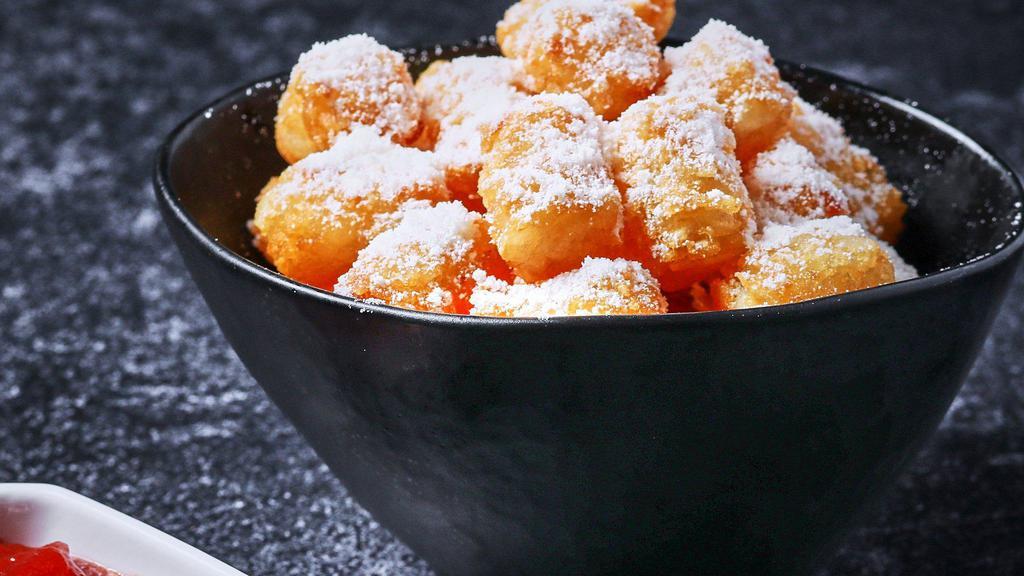 Parmesan Truffle Tots · Tater tots with fresh parmesan cheese and white truffle oil