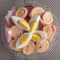 Chef Salad · Ham, turkey, and cheese rolled and sliced on top on a bed of lettuce with hard-boiled egg, t...