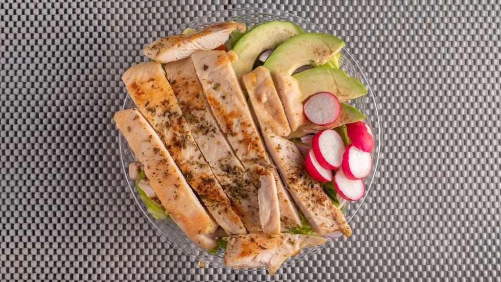 Grilled Chicken Salad · Grilled chicken sliced on a bed of lettuce, avocado, hard-boiled egg, and red onions.