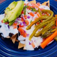 Carne Enchilada/ Spicy Pork Nachos (Homemade Chips) · Spicy pork, tortilla chips, black beans, sour cream, onions, tomatoes, avocado and jalapenos.