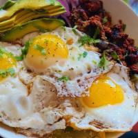 Chilaquiles · Chips covered with green sauce and topped with onions, crema, avocado and Cotija cheese. Thi...