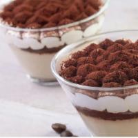 Tiramisu In A Glass · Sponge cake soaked in espresso, topped with mascarpone cream and dusted with cocoa powder