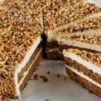 Carrot Cake · Alternating layers of carrot cake spiced with cinnamon, chopped walnuts and pineapple, cover...