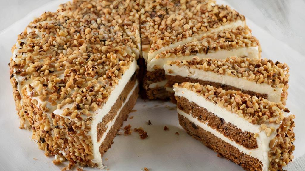 Carrot Cake · Alternating layers of carrot cake spiced with cinnamon, chopped walnuts and pineapple, covered with a smooth cream cheese topping and sprinkled with crushed walnuts.