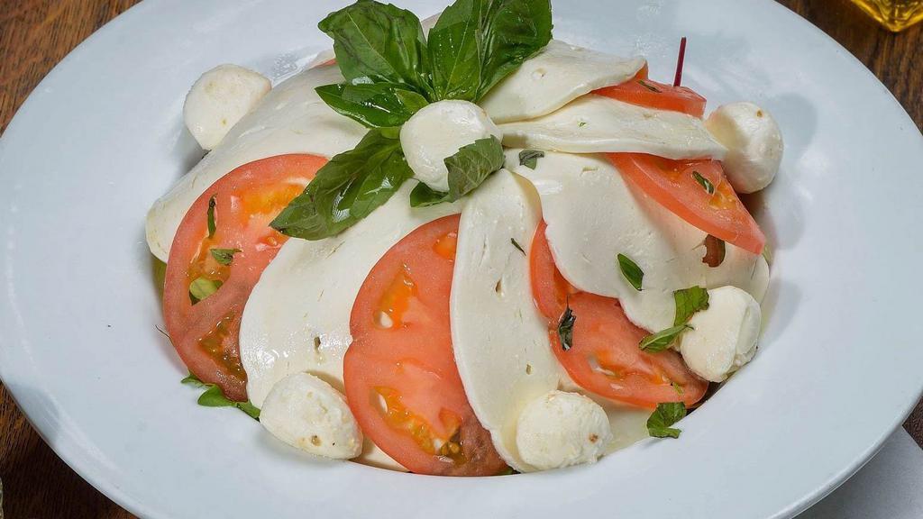Caprese · Fresh mozzarella, tomato, basil, & drizzled with olive oil.