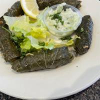 Dolma · Grape leaves stuffed with rice, meat, spices, tomato and parsley