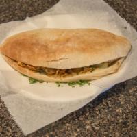 Lamb Shawarma Sandwich · Lettuce, tomatoes, pickles, tahini sauce, onions.