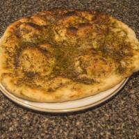 Zatar Manakeesh · Vegetarian. flat bread  topped with thyme and olive olive oil. served fresh from the oven