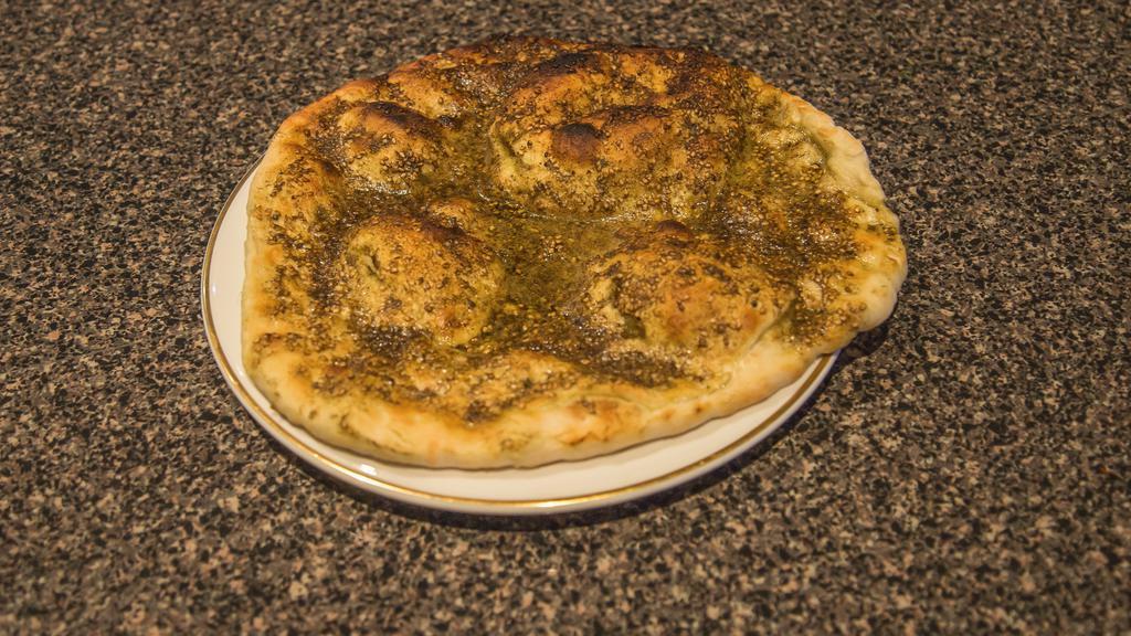 Zatar Manakeesh · Vegetarian. flat bread  topped with thyme and olive olive oil. served fresh from the oven