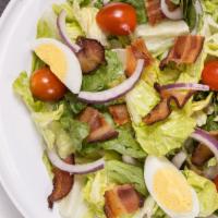 Chicken Caesar Salad · Romaine lettuce, hard boiled egg, grape tomatoes, red onion, bacon and croutons