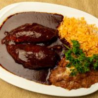 Mole Poblano · Chicken Breast topped with mole sauce and sesame seeds served with corn tortillas.